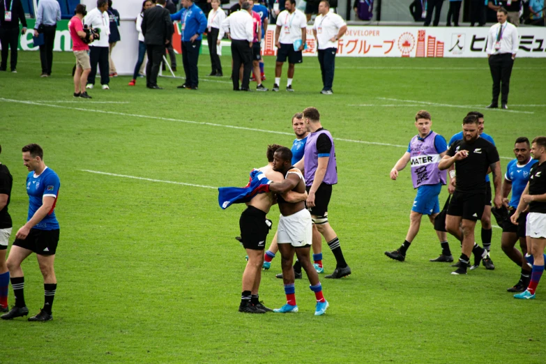 several men are emcing each other during a soccer game