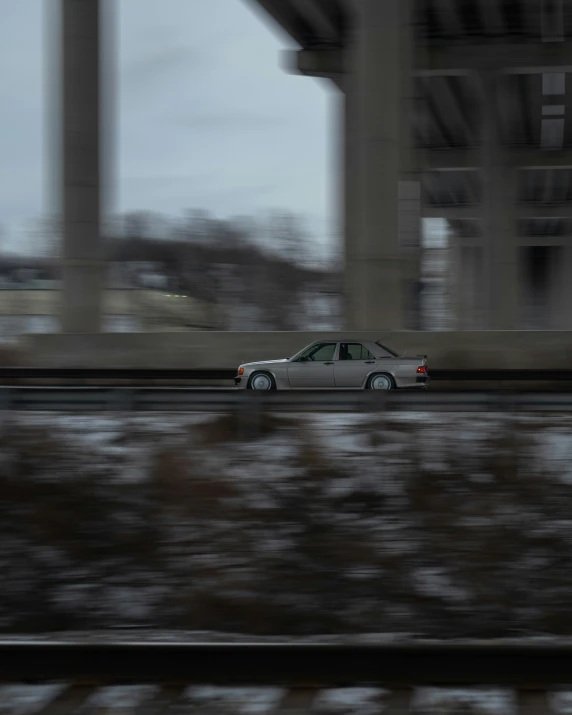 a gray car on the road and another car passing by