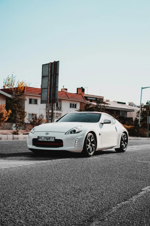 a white car parked on the street near some buildings