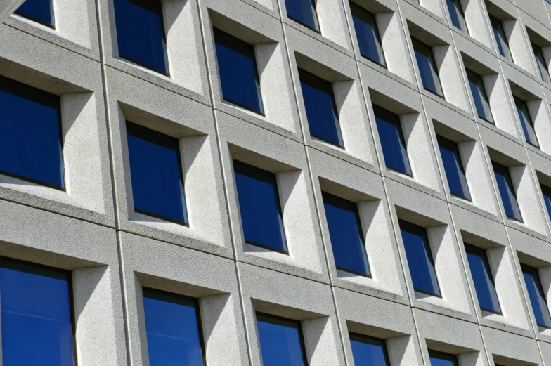 the corner of a building, with blue windows