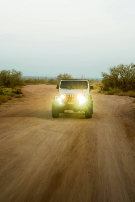 the light is on in the back of the truck on the dirt road