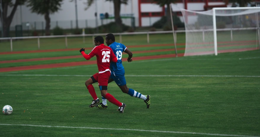 a soccer game on a field with players in motion