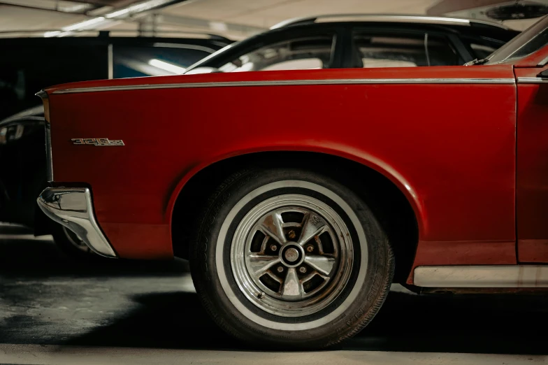 an old and worn red mustang parked in a garage