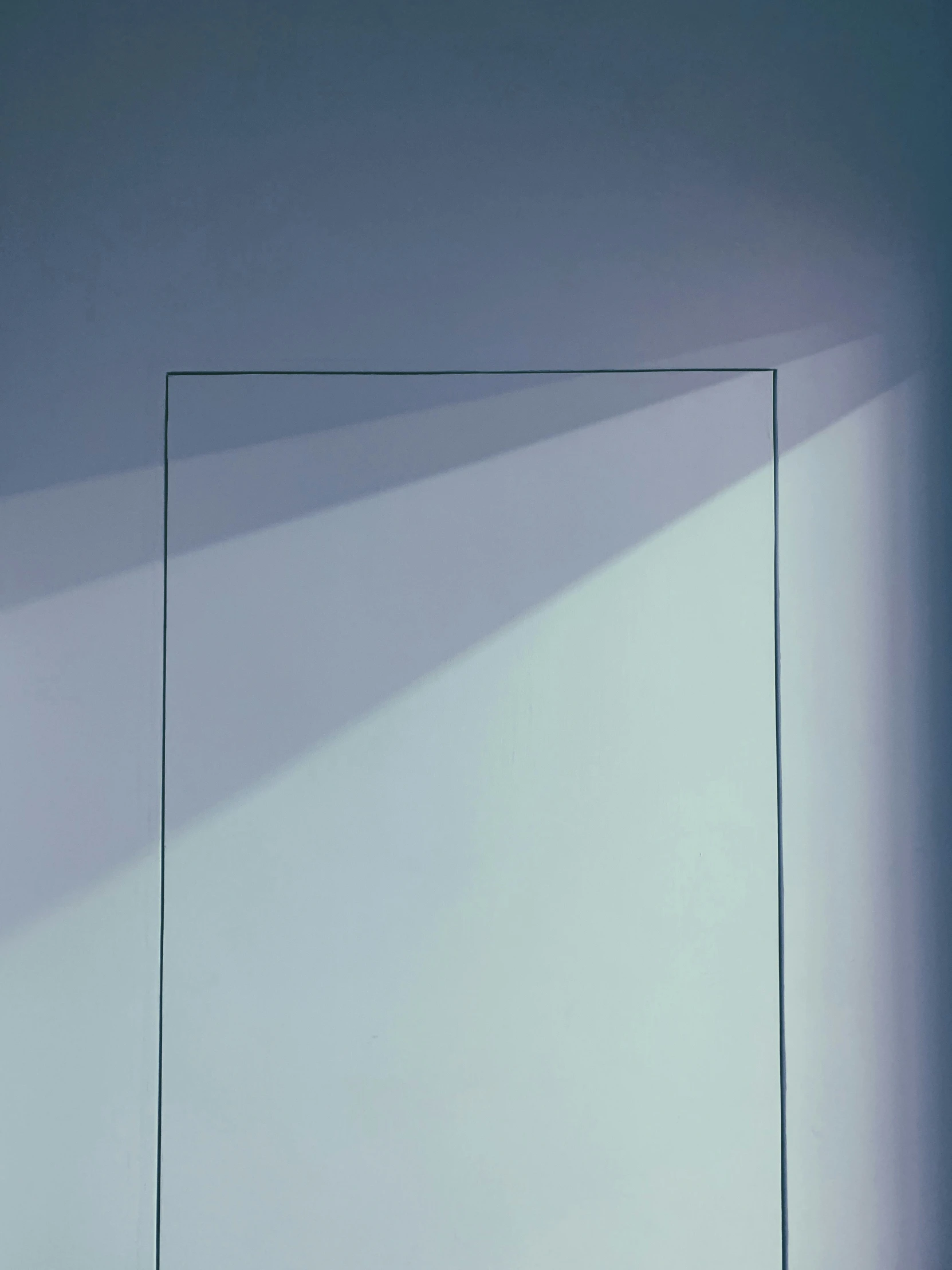 a rectangle in an empty room, with a painting hanging above