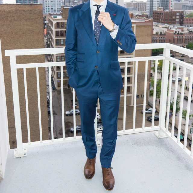 a man in a suit is on a balcony