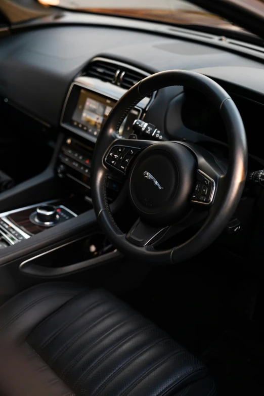 the inside of a car with a steering wheel, instrument and radio