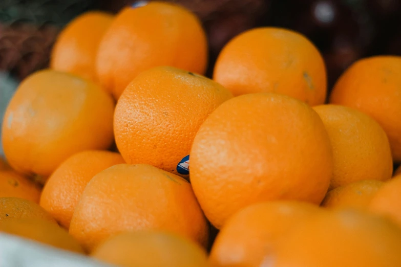 a pile of oranges that are laying on top of each other