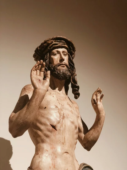 statue of jesus holding a basketball in it's right hand