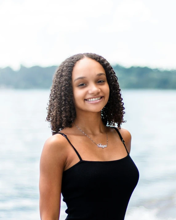 a black woman smiling with her hands on her hip