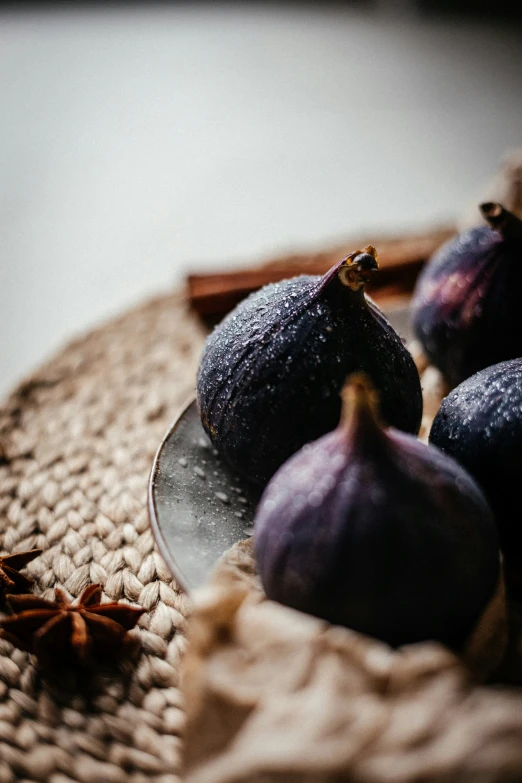 figs and spices on a plate on an old cloth