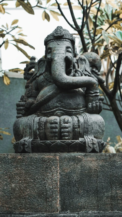 an elephant statue is displayed by the cement