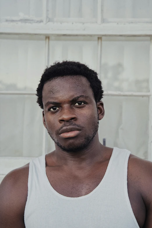 an african american man in white tank top