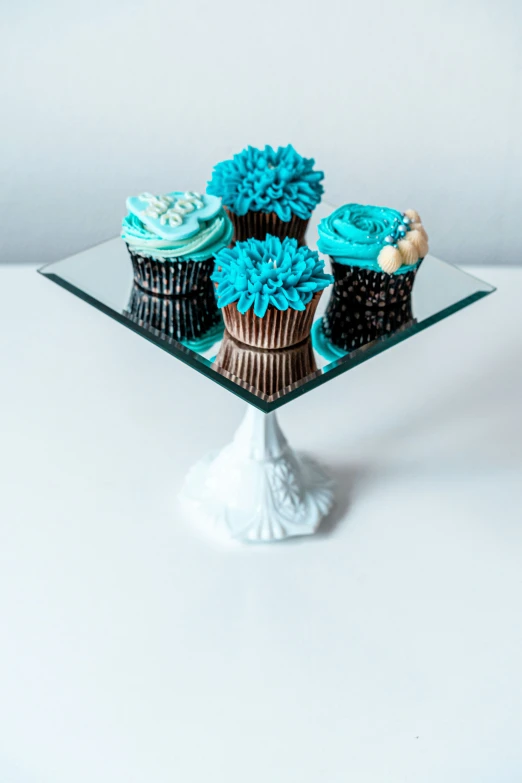 blue and black cupcakes in decorated chocolate cupcake cases