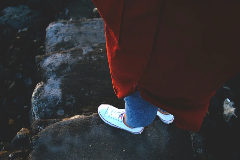 a persons'feet, walking on rocks outside