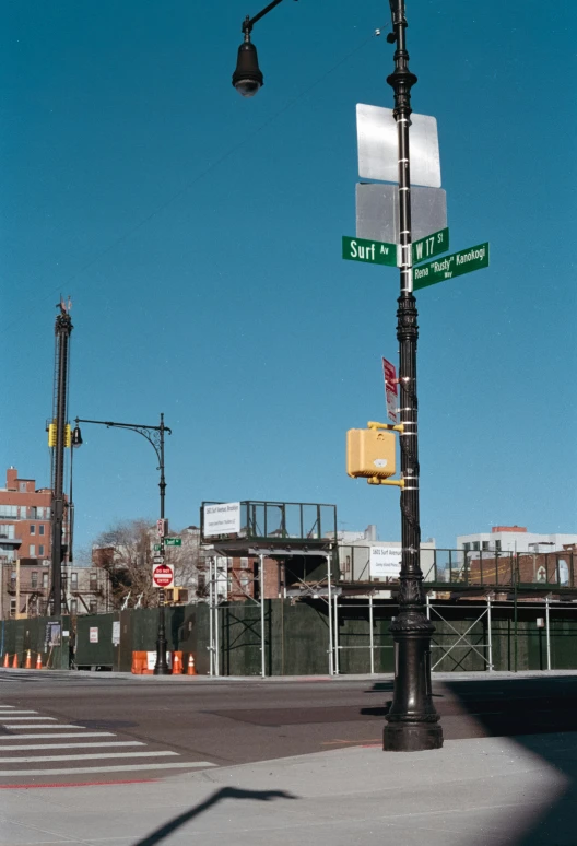 a light pole with signs and other street signs