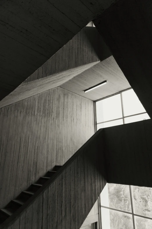 a stairway leading up to a window with a skylight above