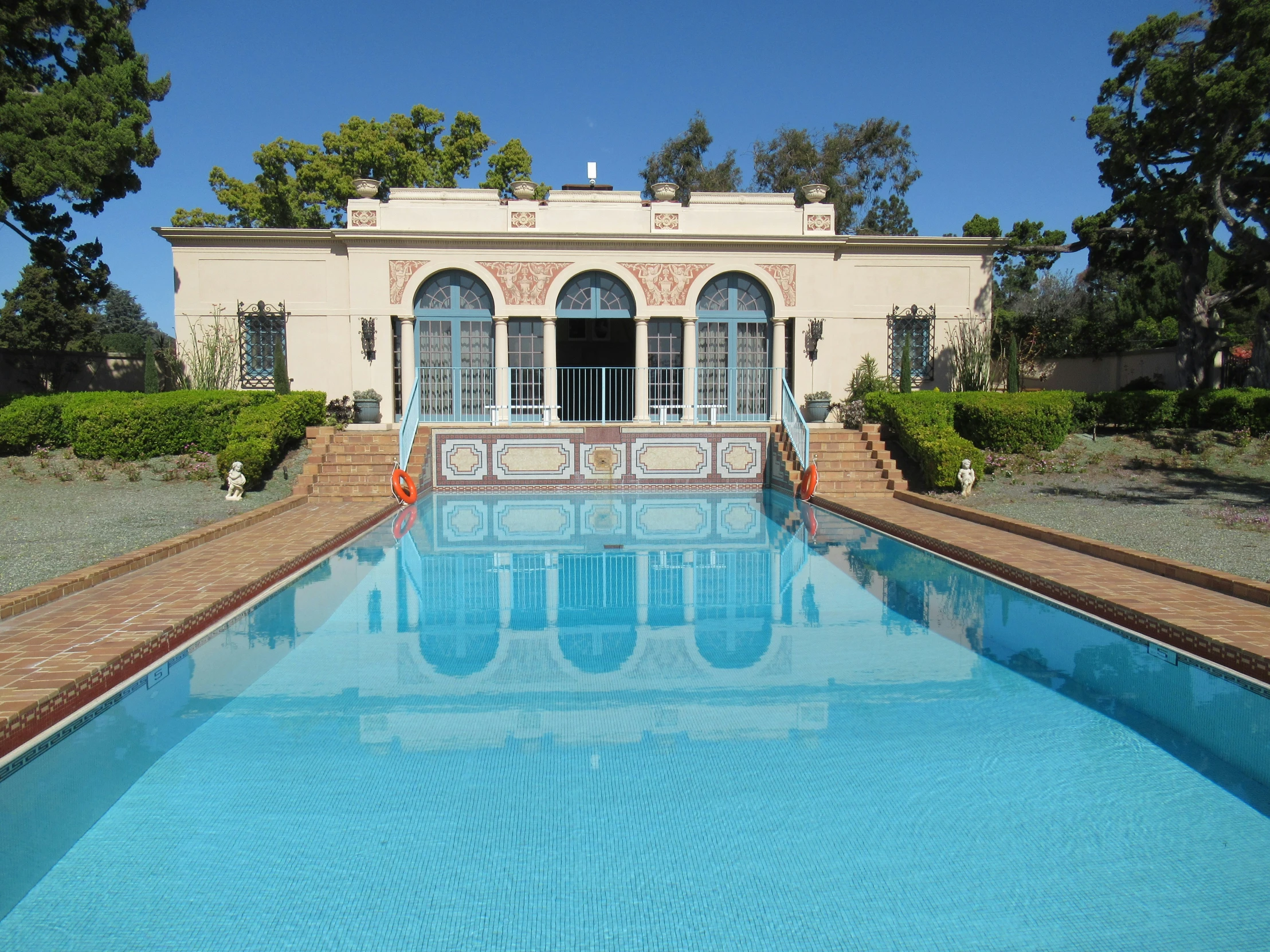 large blue swimming pool in front of home