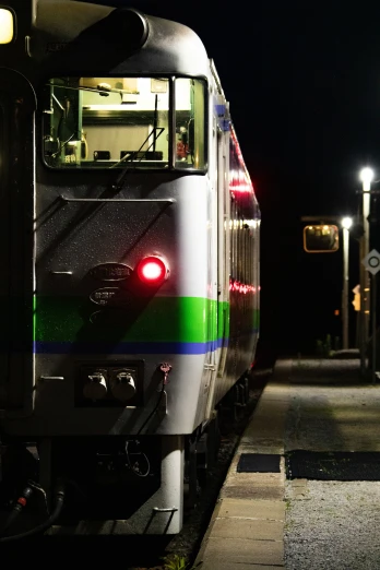 a train sitting at the station and stopped at night