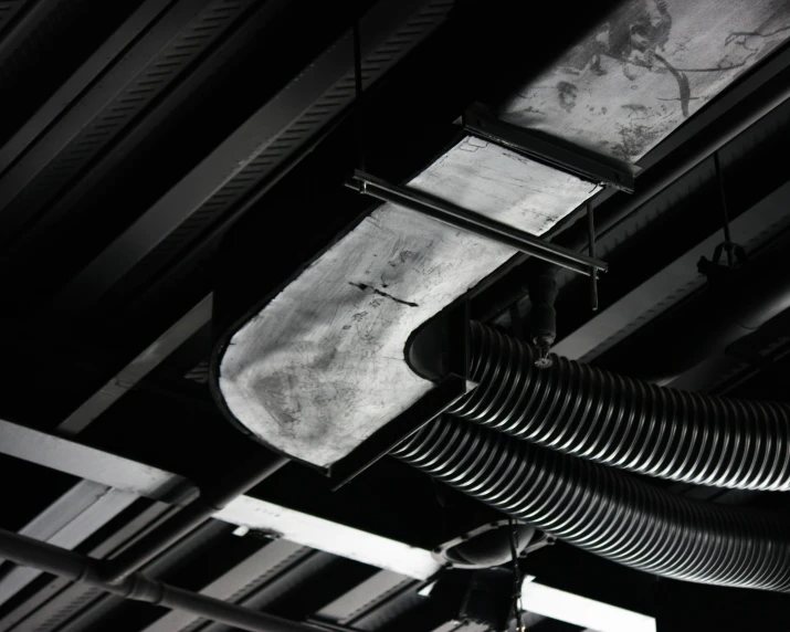 a black and white po of some pipes attached to a ceiling