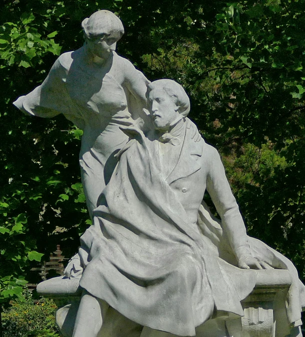 a statue of a person sitting on a bench