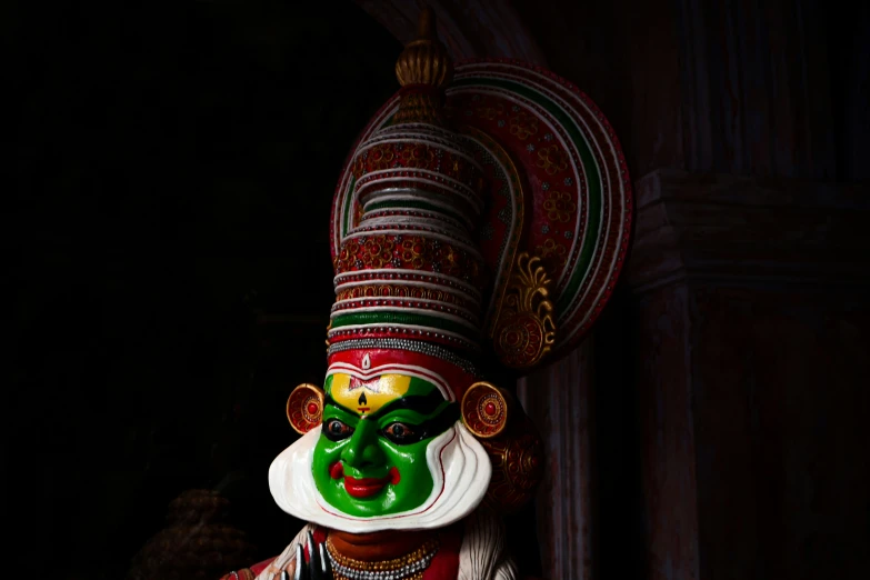 a person with a green face and red body