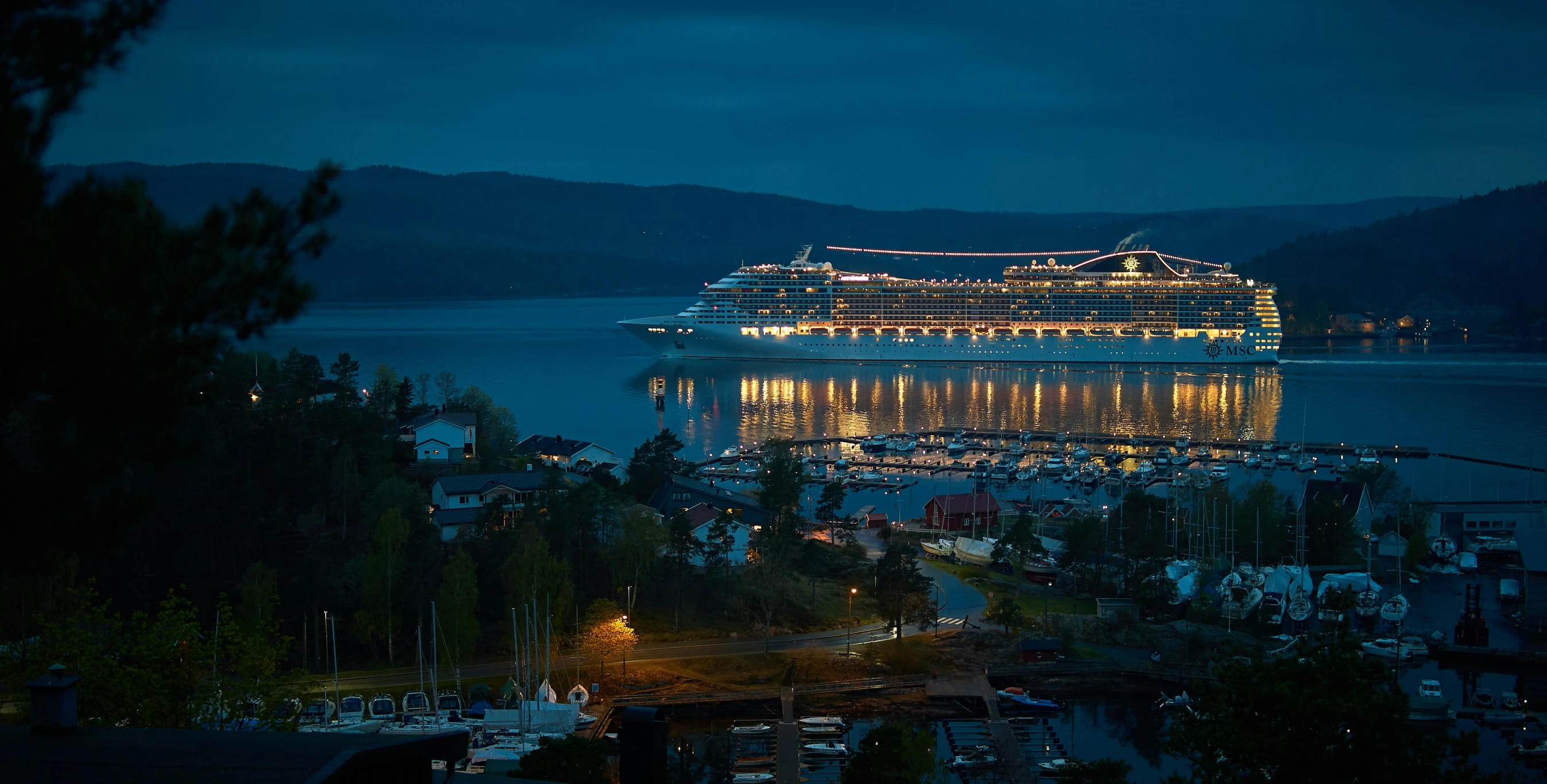 a cruise ship is seen at night with the lights on
