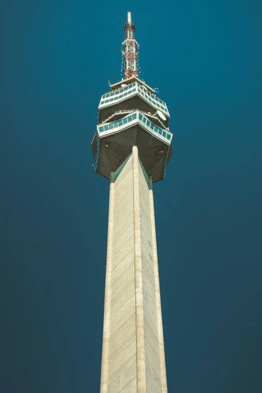 an airplane flying over the top of a tower