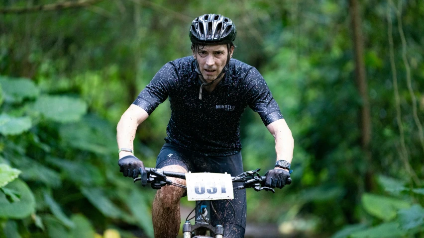 a man is riding a bicycle in the woods