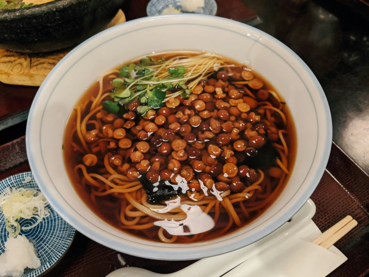 a bowl of food containing beans and noodles