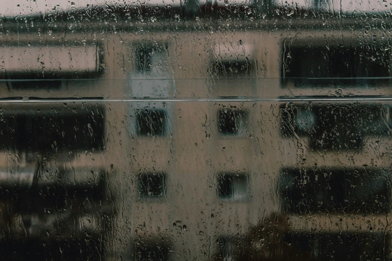 a view from a rainy window showing the outside and outside of buildings