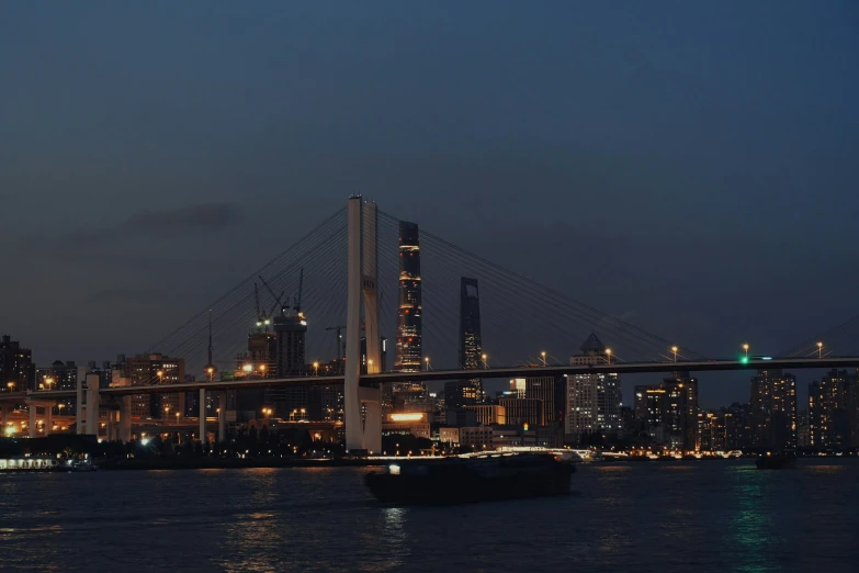 a bridge crossing over the water near some tall buildings