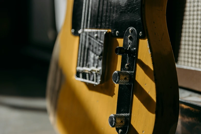 a close up po of the pickup on a yellow guitar