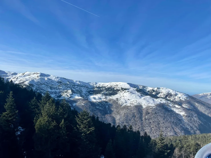 a view of the mountains from the top of a hill