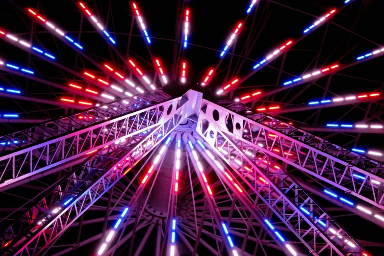 a ferris wheel with colorful lights is lit up