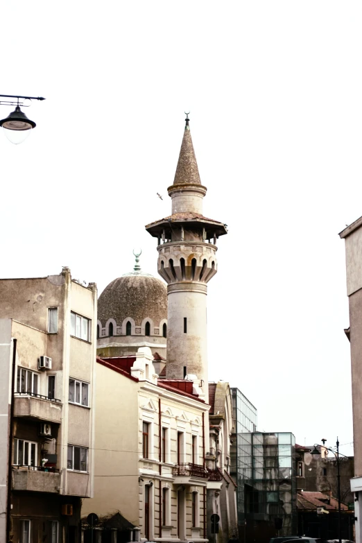 a street view of some buildings, one with a clock and a tower