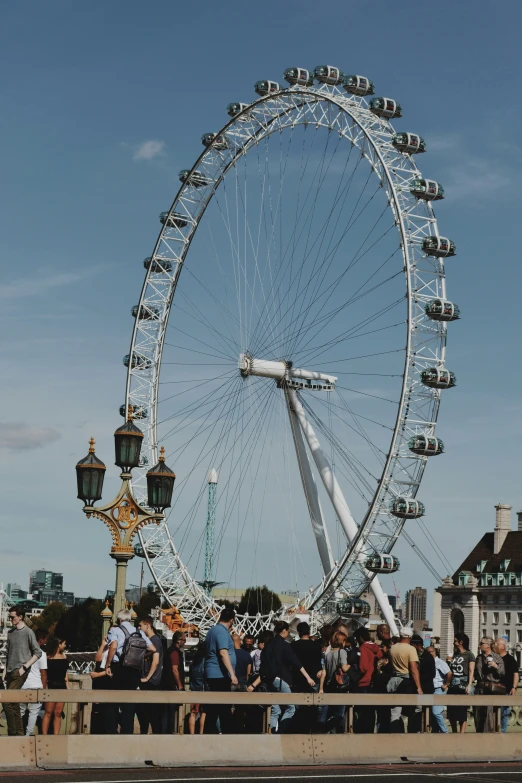 a ferris wheel with people looking at it