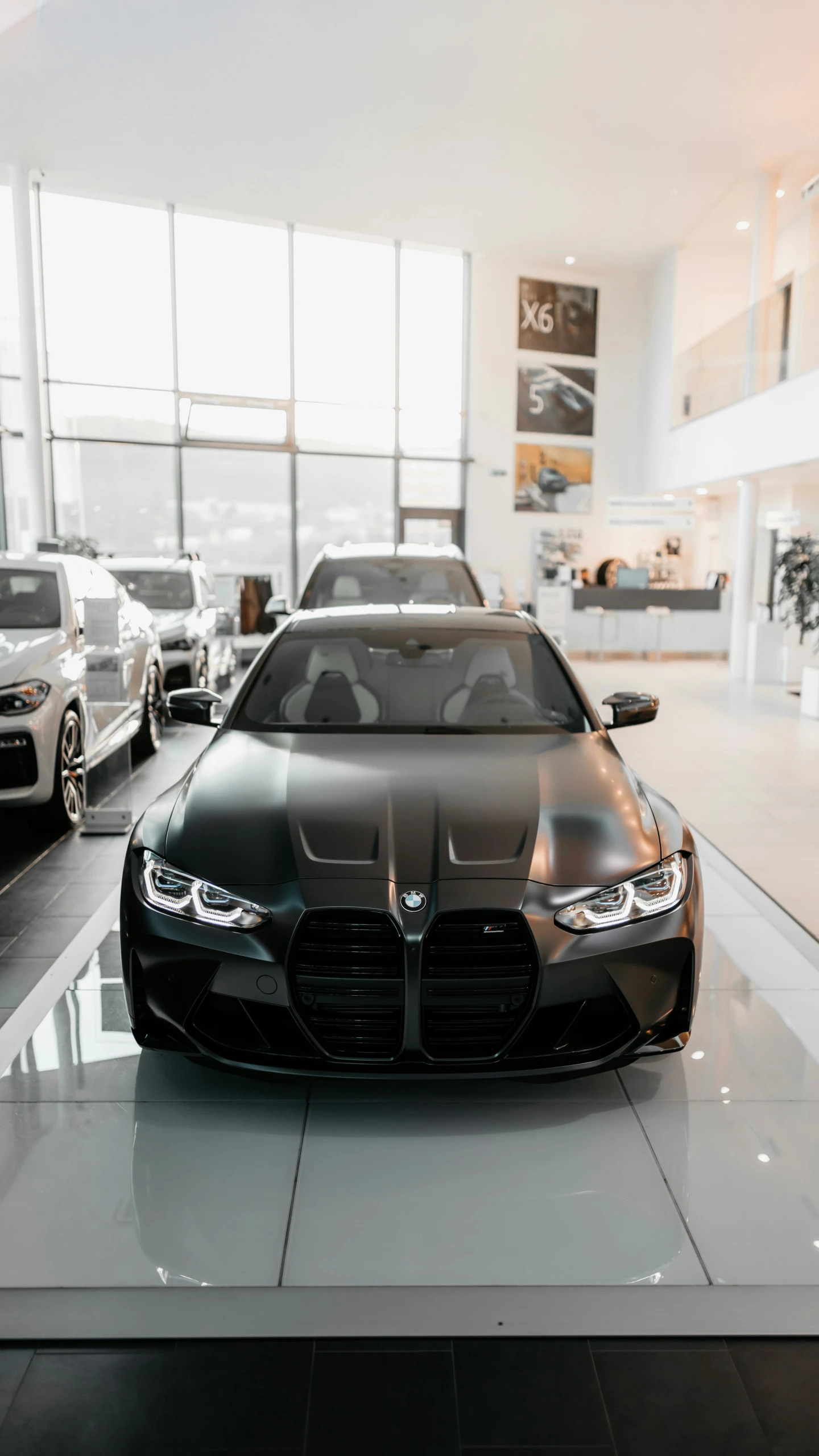 a gray car parked in front of another silver car