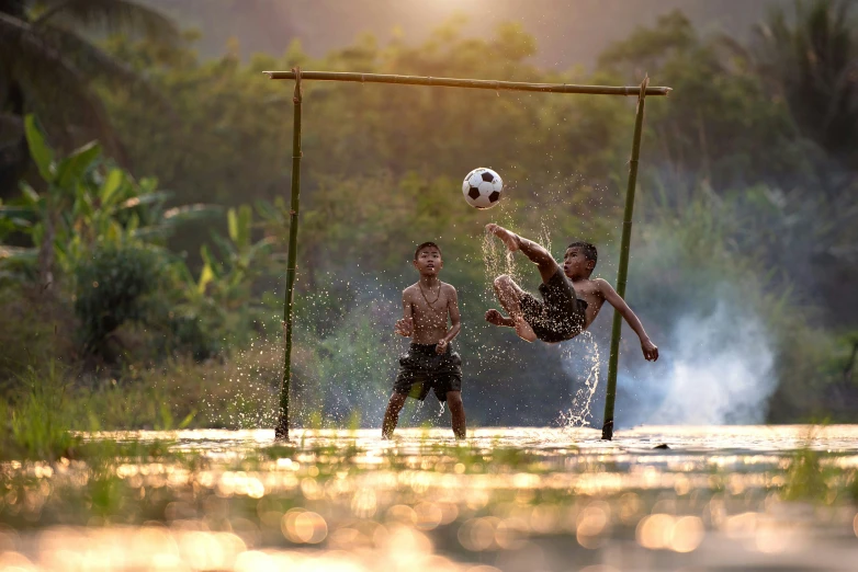 the boys are playing soccer on the water