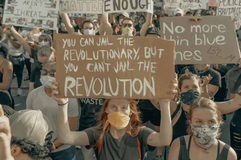 a group of people holding up protest signs