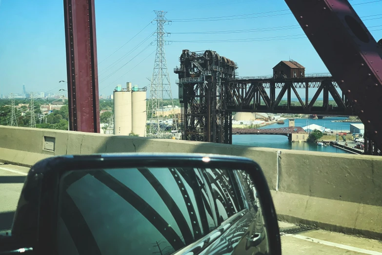 an old structure on a bridge, as seen from a car window
