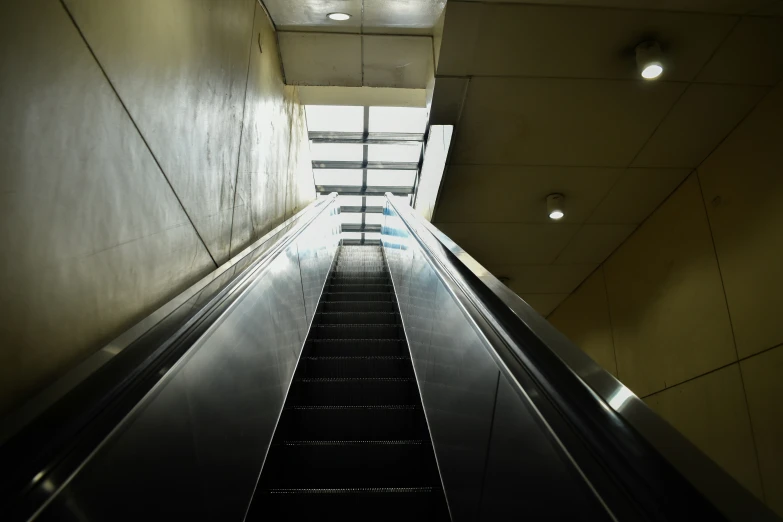 the view from an escalator of a ramp leading to a large building