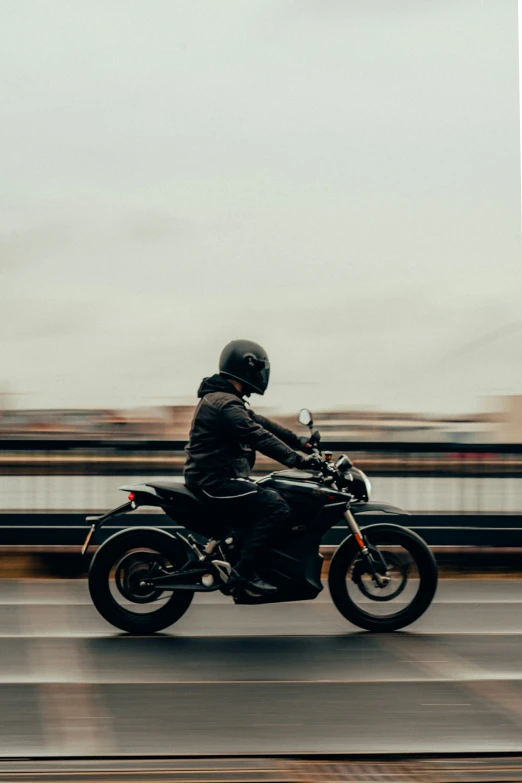 a man is riding his motor cycle through the street