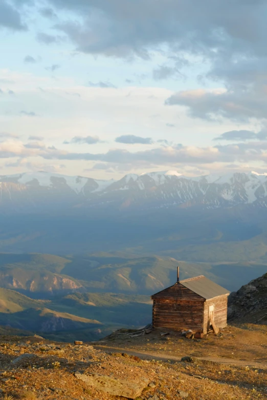 two small cabins sitting on top of a mountain