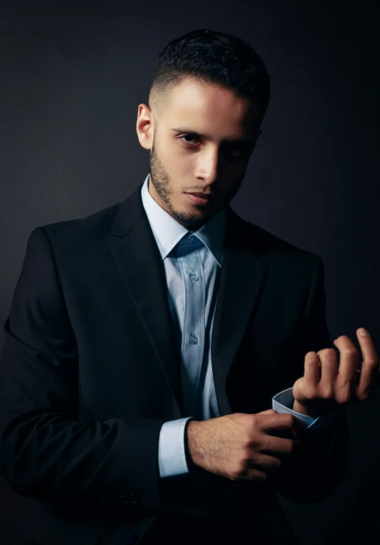 a man in a suit and tie holding a cell phone