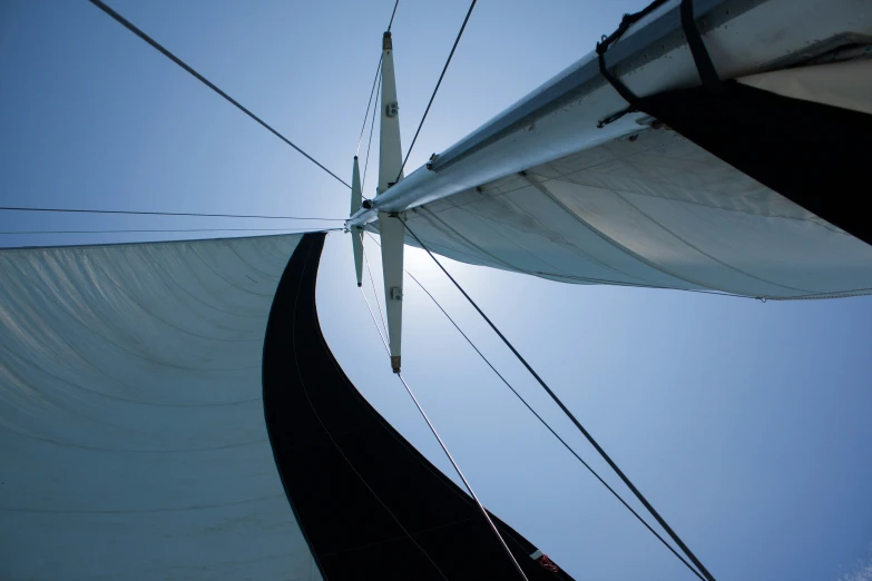 a s looking up at the sails of a sailboat