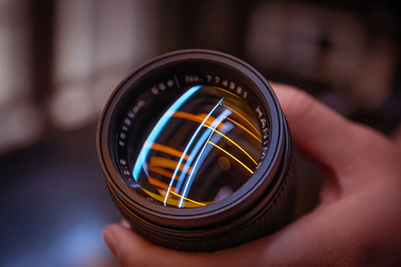 someone holding up a camera lens to take a closeup of the lens