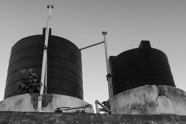 a very large tower and some pipes on a wall