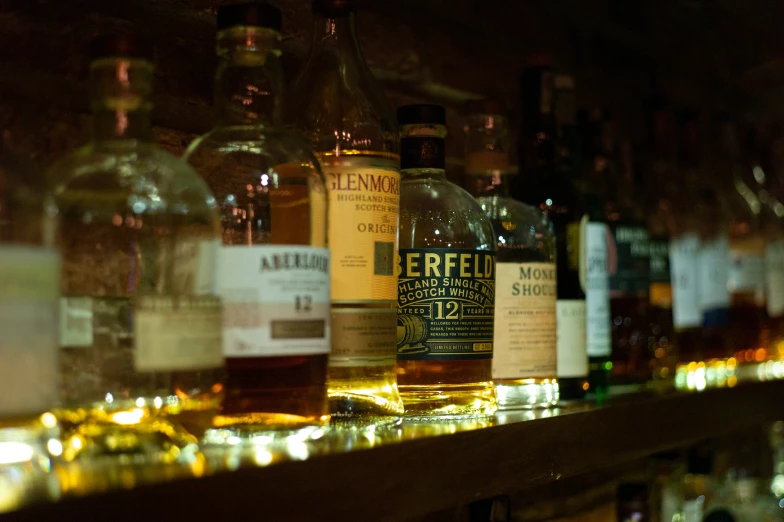 an assortment of liquors on a shelf in a store