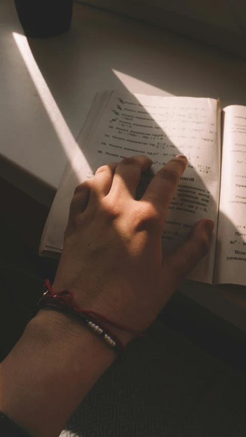 the sun streams through the window onto a person's hand