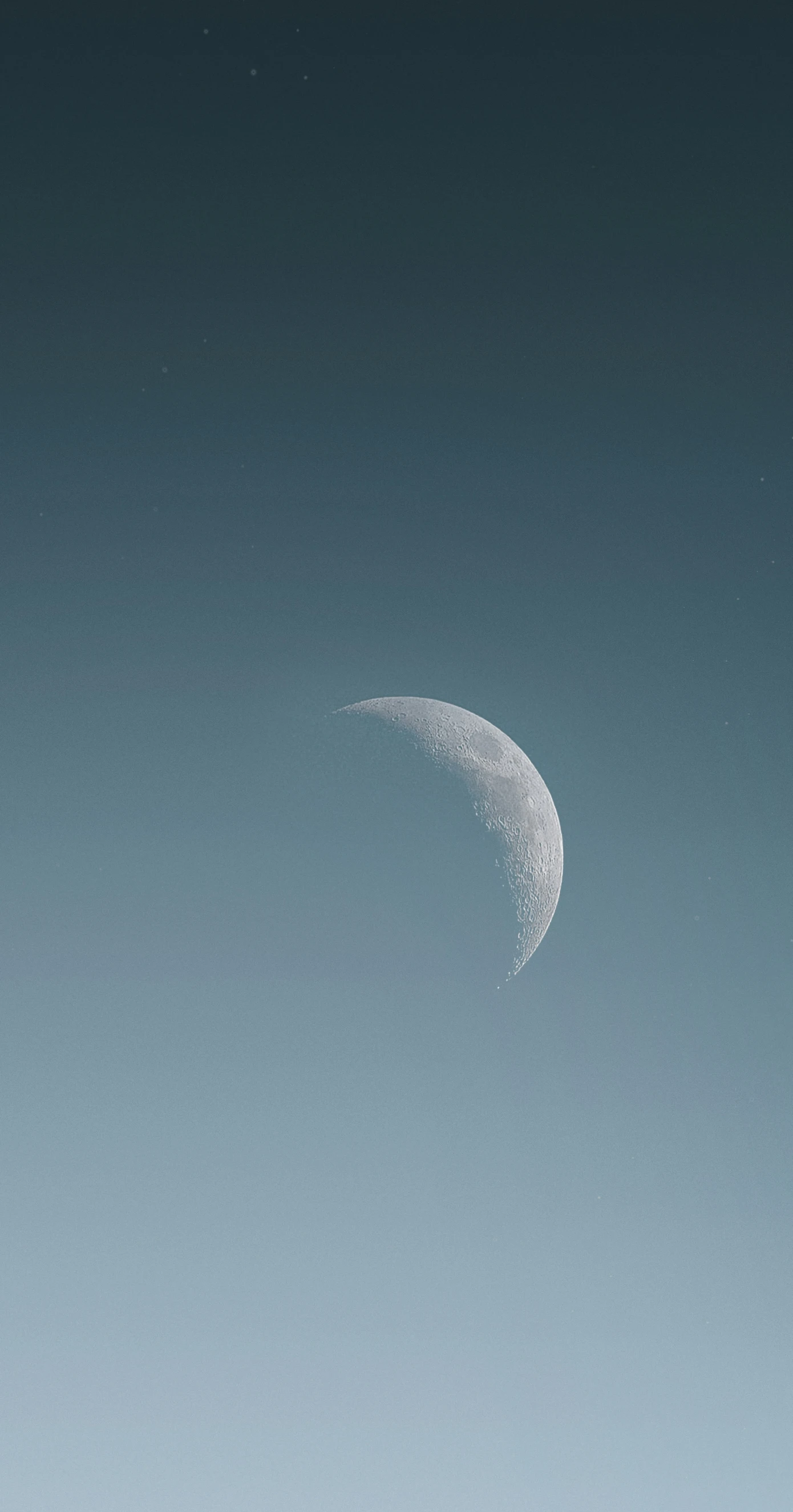 a moon in the sky with two people on the other side